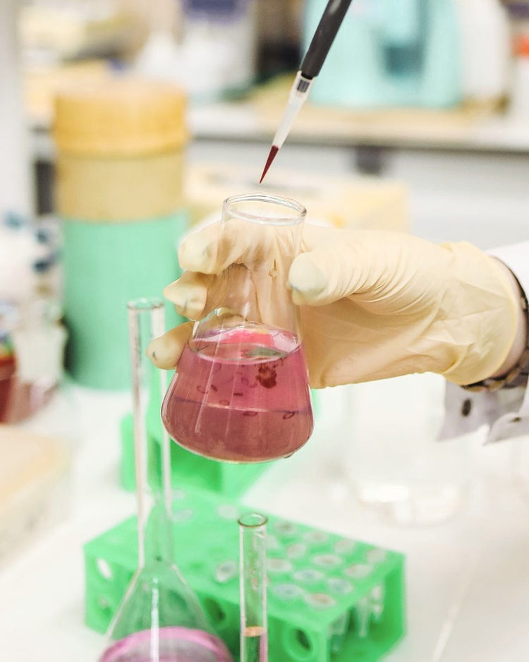Laboratory pipette above a flask
