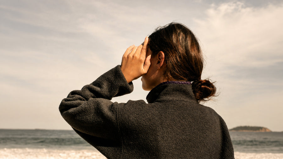 Woman shielding her eyes at the beach