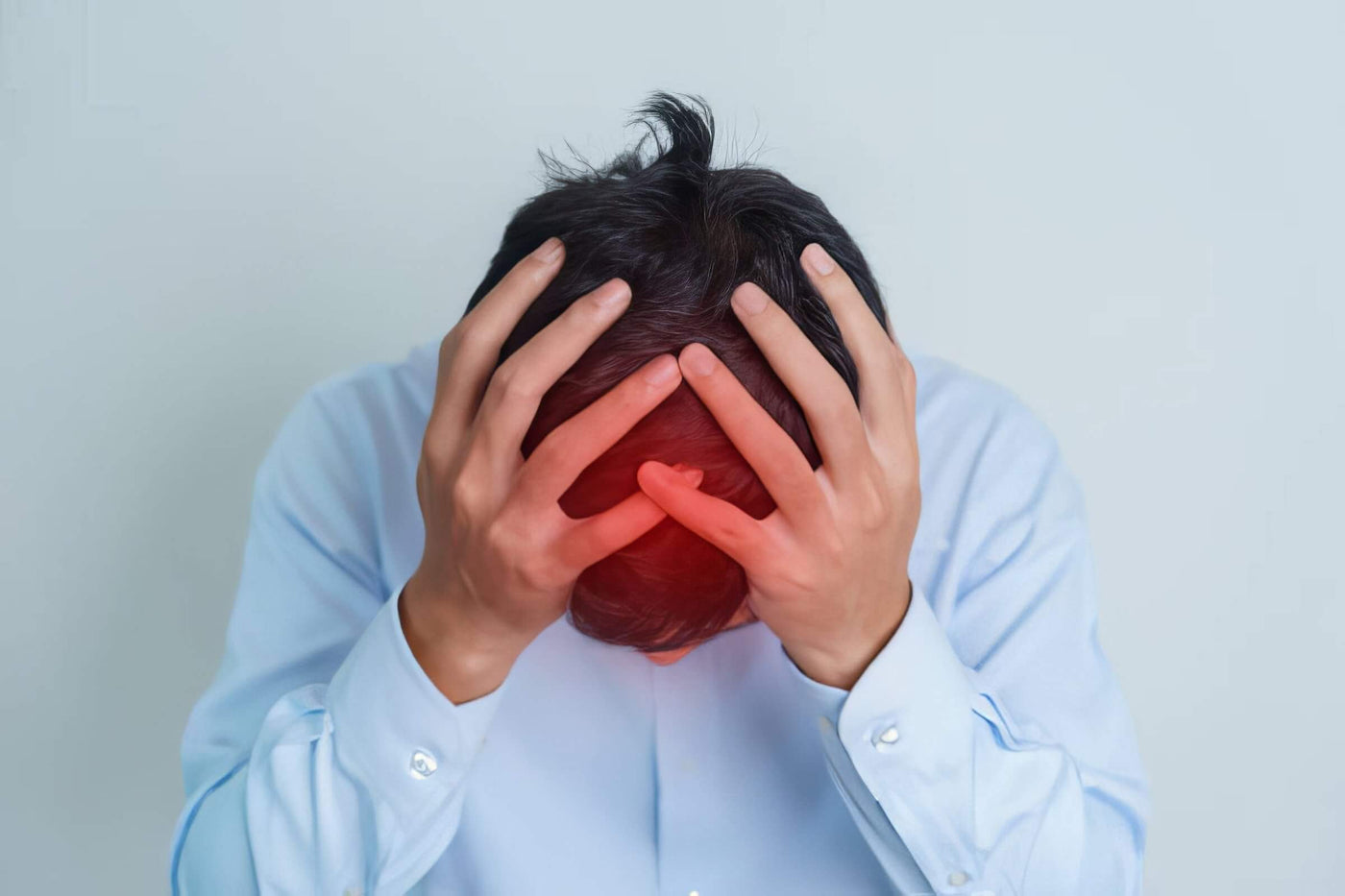 Man holding head with red highlighted pain area
