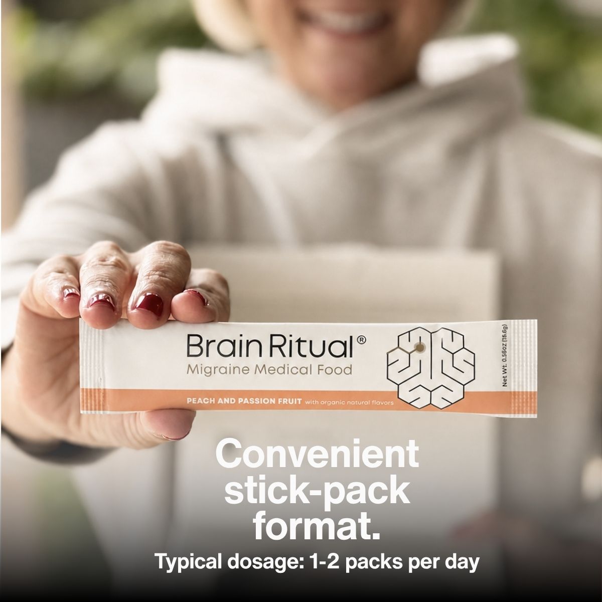 Person holding a Brain Ritual peach and passion fruit stick pack. Image text reads: Convenient stick-pack format. Typical dosage: 1–2 packs per day.