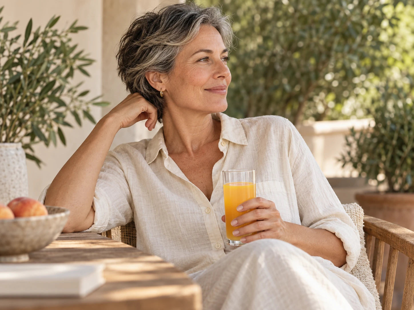 Woman holding a peach drink during a quiet terrace break