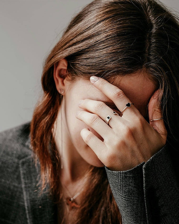 Woman covering her eyes with one hand