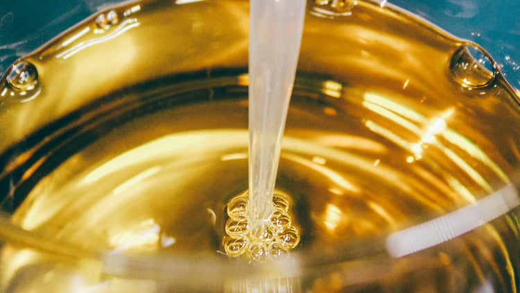 Gold liquid pouring into a vessel