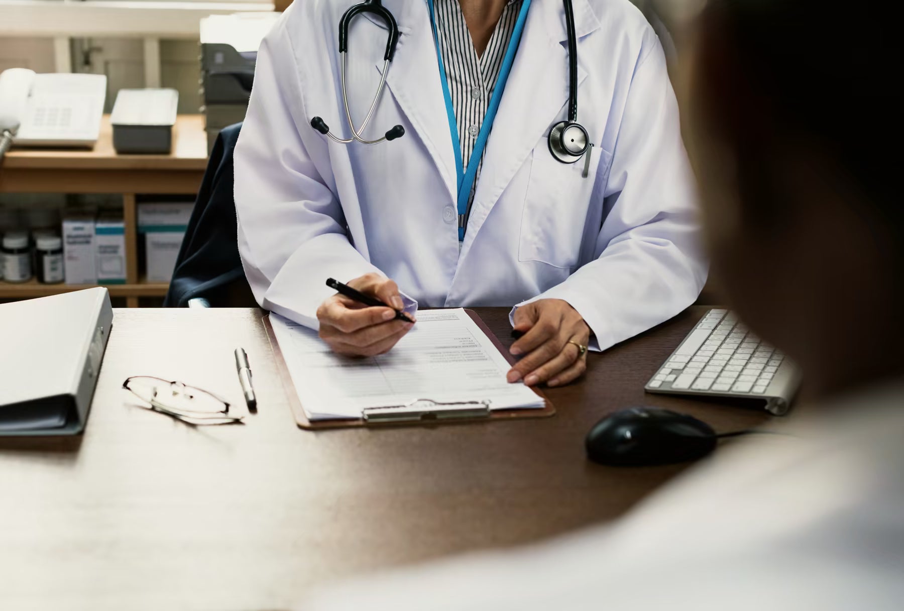 Doctor consulting with a patient at a desk